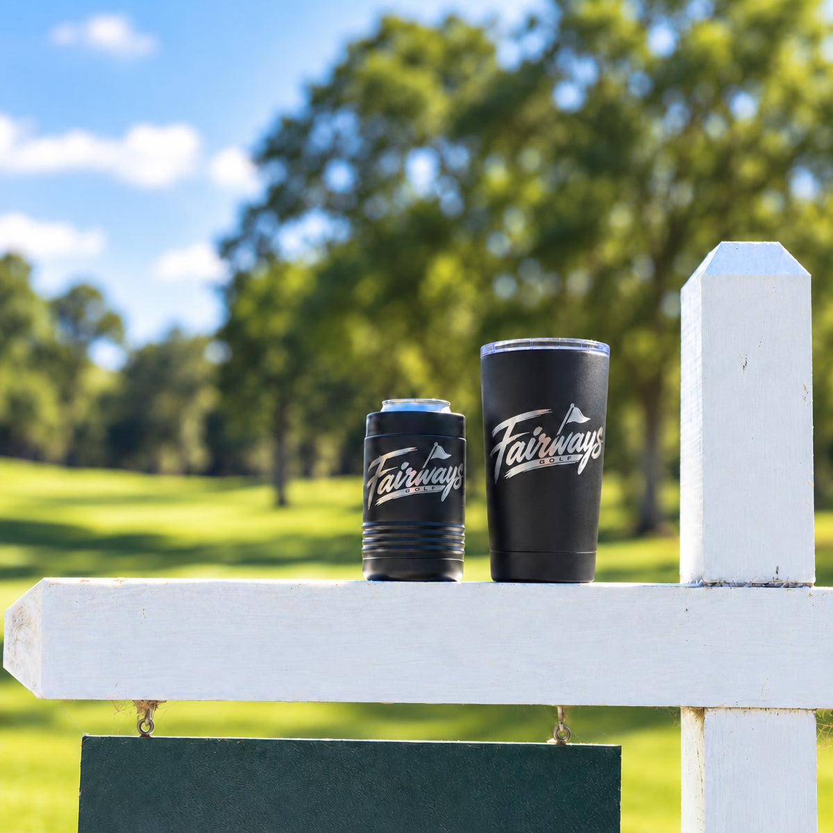 Black Fairways Golf 20 oz tumbler on the right beside a Fairways can holder on the course; additional product shown for context