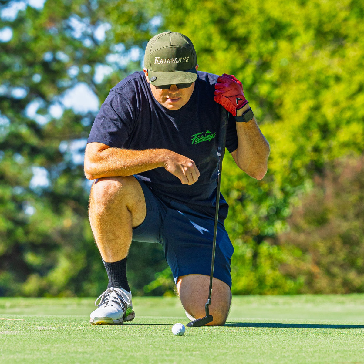 Olive FAIRWAYS cap worn while lining up a putt