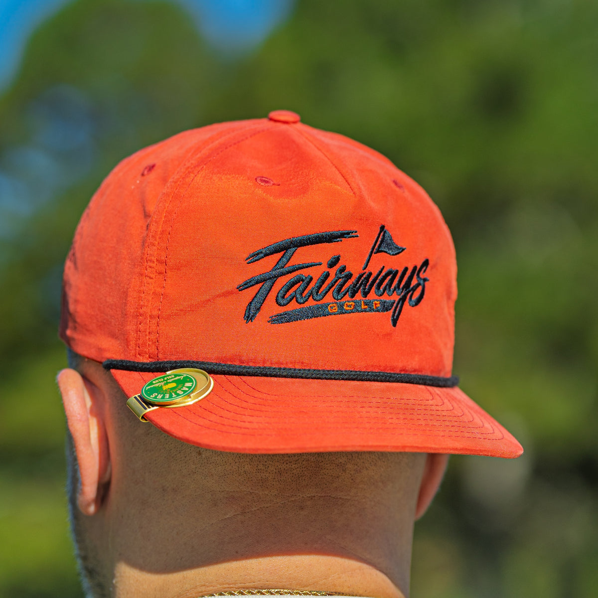 Orange Fairways rope cap script embroidery, brim and rope detail; clip-on ball marker visible