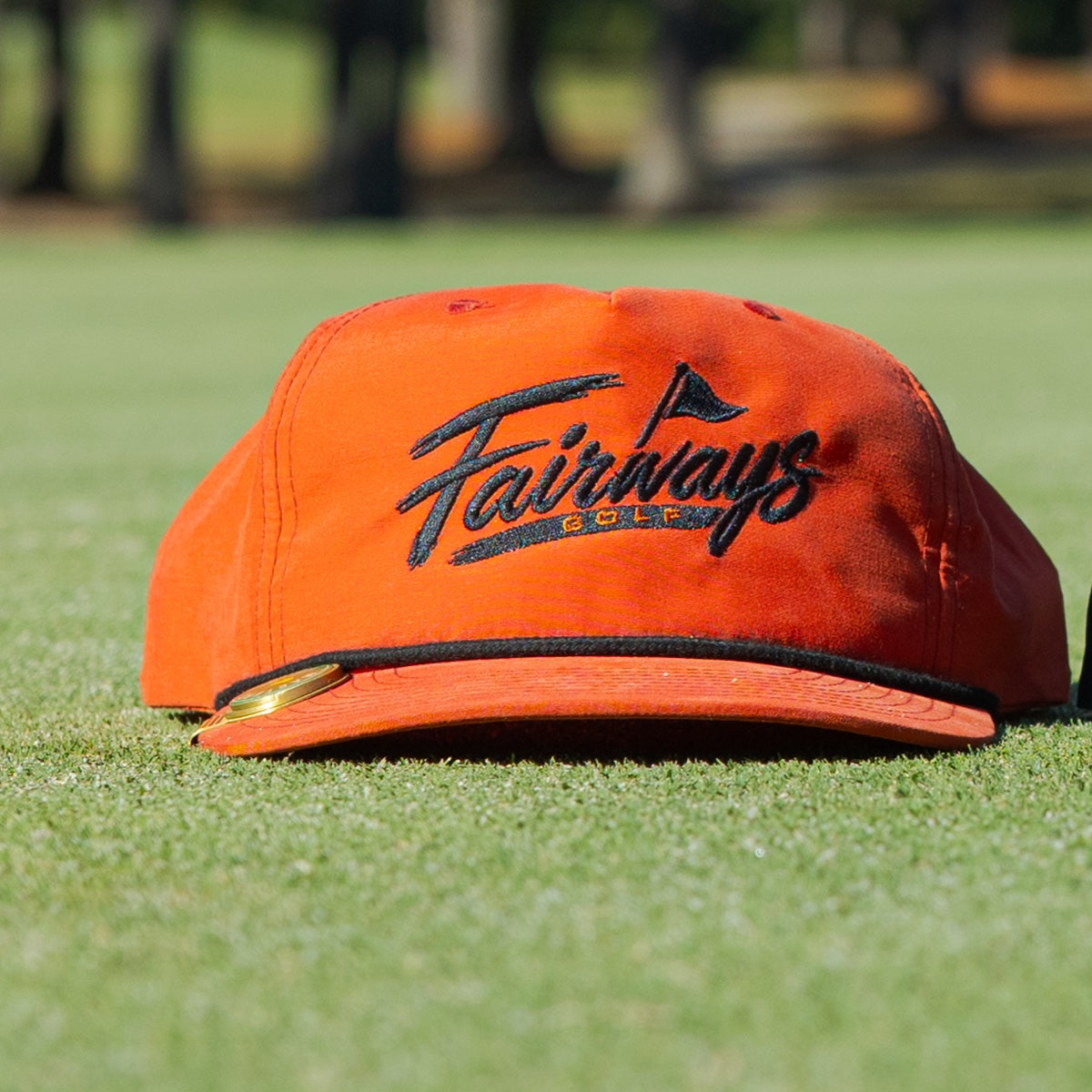Orange Fairways rope cap front view on the putting green